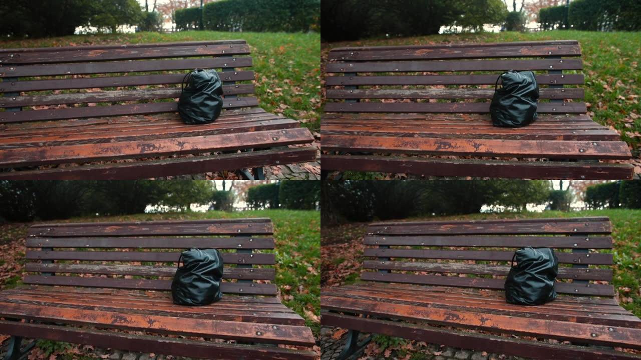 公园长椅上被遗忘的黑色皮革手提包，没人。失物招领服务