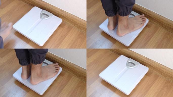 特写脚男人体重秤，用于测量体重减轻。体重秤以健康减肥概念。