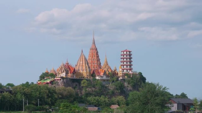 时光流逝的Wat tham sua或tiger cave temple，带有绿色的茉莉稻田，蓝天，阳