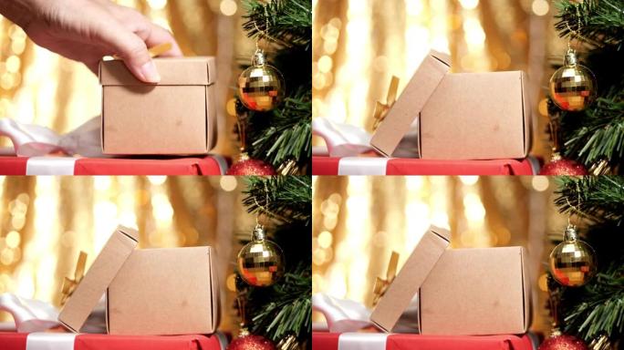 打开带有圣诞灯背景的礼品盒。