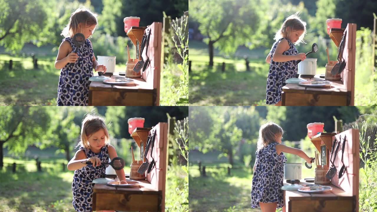 小女孩穿着裙子，在户外的小厨房里玩耍和做饭