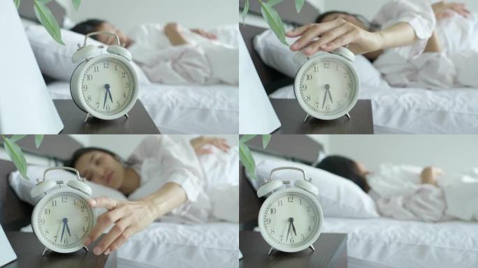 女人早上关闹钟。
