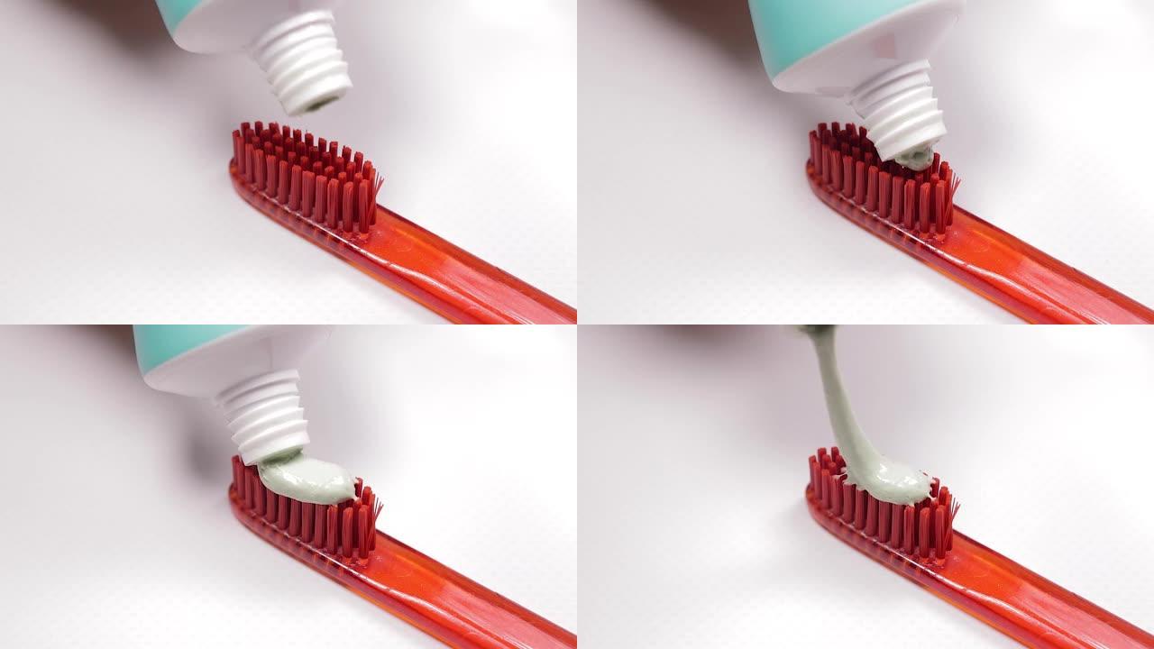 红色牙刷，白色背景上有绿色天然牙膏。