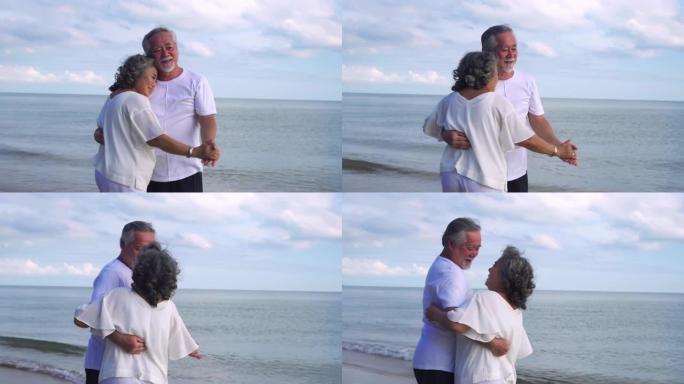 可爱的高级夫妇的特写镜头正在一起享受时光，跳舞庆祝他们在海滨的永恒之爱。