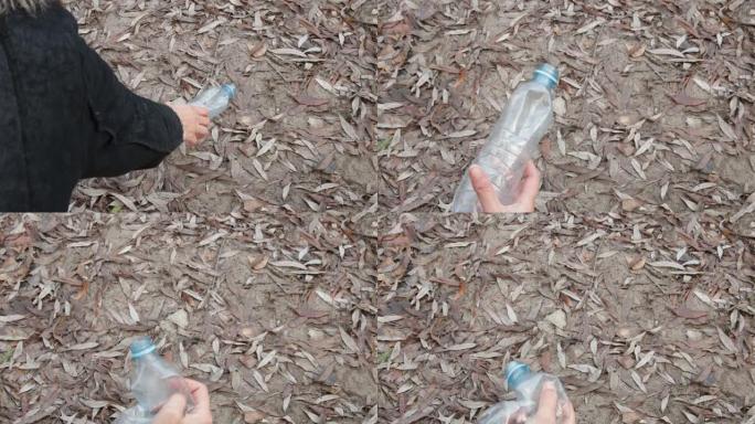 塑料垃圾。女孩从地上捡起一个塑料瓶