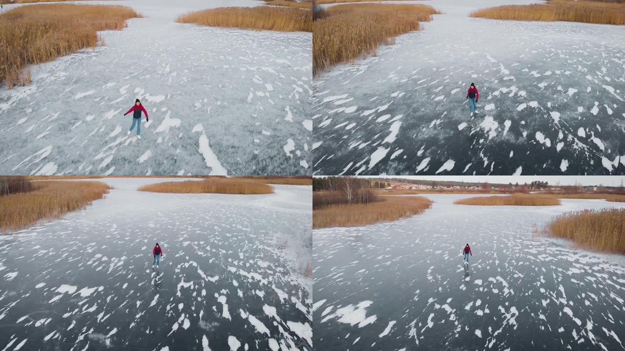 鸟瞰图。一名年轻女子在冰冻的湖上滑冰