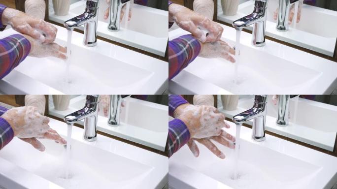 卫生概念。在水龙头下用肥皂和水洗手。洗净手上的污垢，注意身体清洁，预防冠状病毒感染，特写