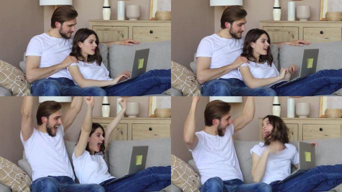 幸福的夫妻坐在客厅的沙发上放松，一起使用笔记本电脑在线购物，看电影，喝红酒。