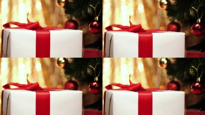 白色礼品盒，红丝带，圣诞树背景。