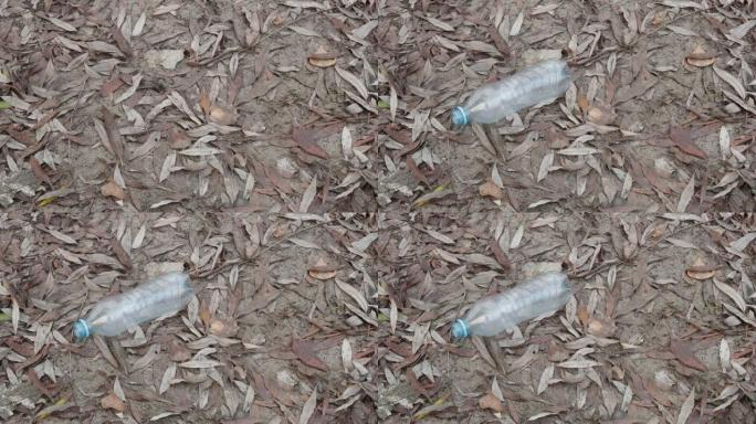 塑料垃圾。一个空塑料瓶被扔到地上。塑料垃圾