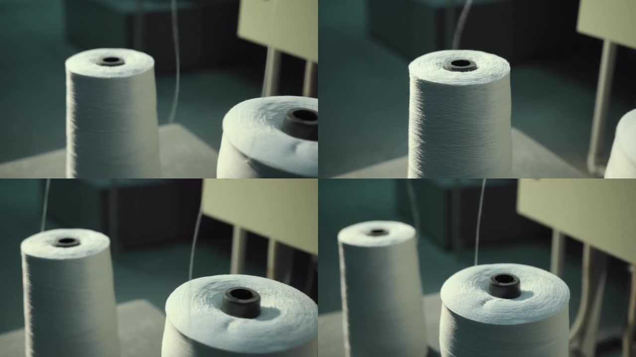 纺织线行业的排行。线轴白线站在机器上。特写