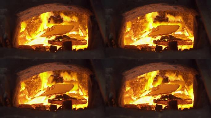 火。红色壁炉和框架燃烧的木头，在炉子里放煤，以提供温暖，热量和烟雾。露营。
