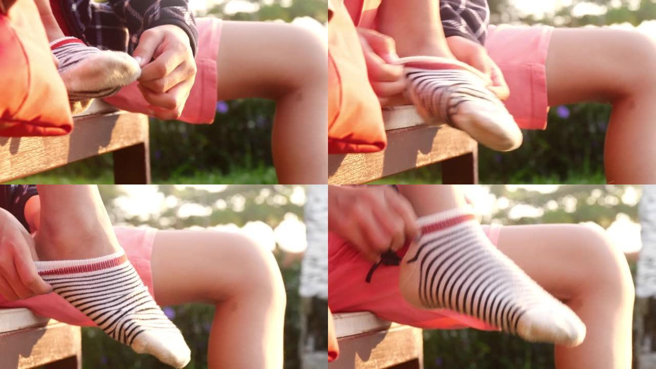 女孩早上在公园里穿滑板鞋前穿袜子，准备玩耍。