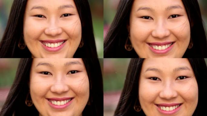 快乐的亚洲大年轻女子对着镜头特写肖像脸微笑