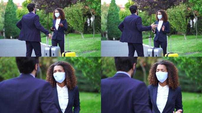 4k视频情侣同事在商务旅行中戴着防护口罩抵达酒店