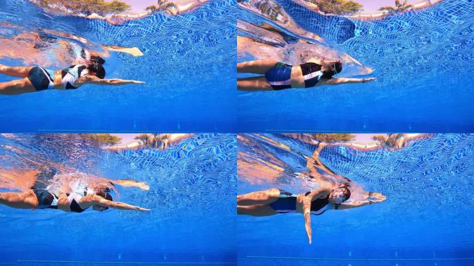 水下半身特写自由式游泳的轨迹视图女人穿两件套泳衣