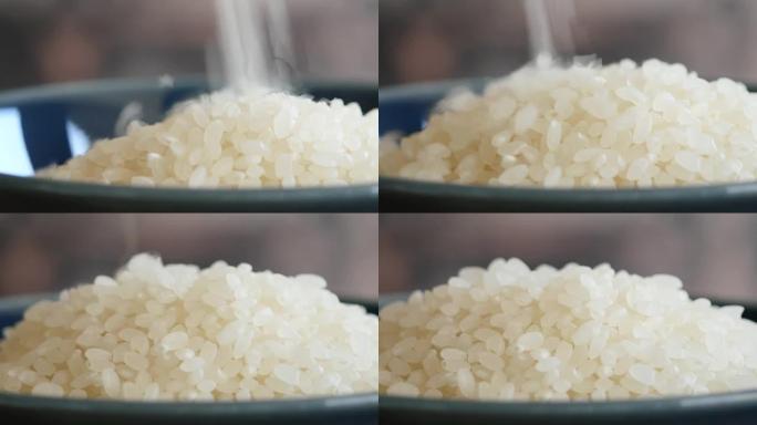 精米。碗里新鲜生米的特写视频。
