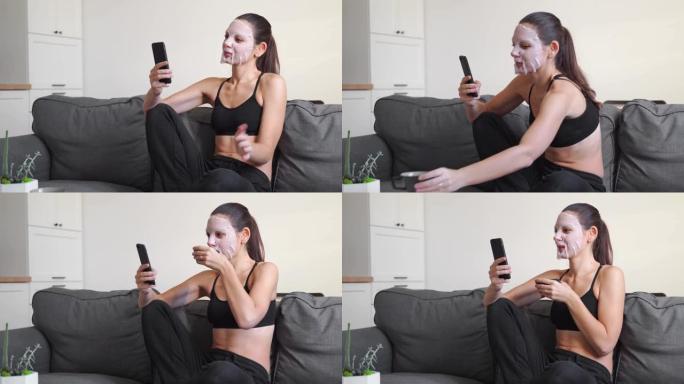 年轻的千禧一代妇女在家在脸上涂布罩并进行视频通话。健康放松时间