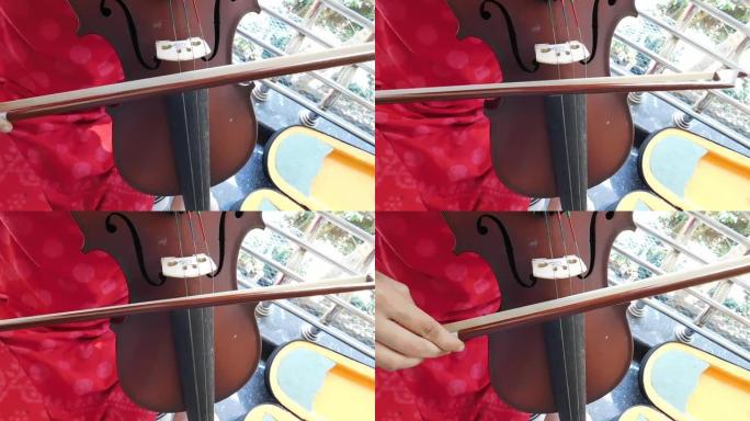 一个女孩演奏的乐器 (小提琴) 的特写视图