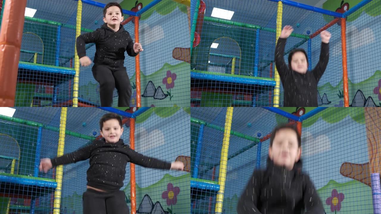 5岁男孩在游戏中心的蹦床上跳起快乐