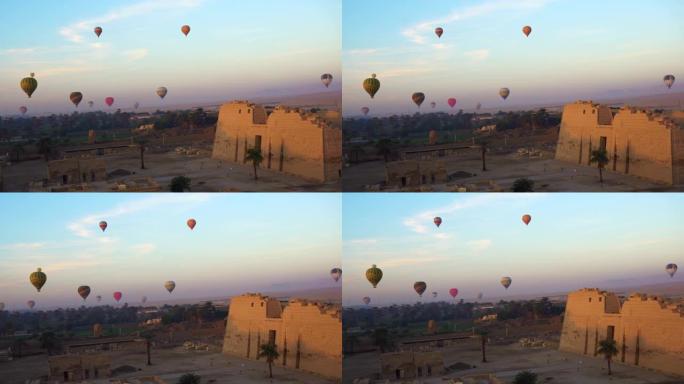 从埃及卢克索国王谷附近的热气球上鸟瞰穿过Medinet Habu神庙