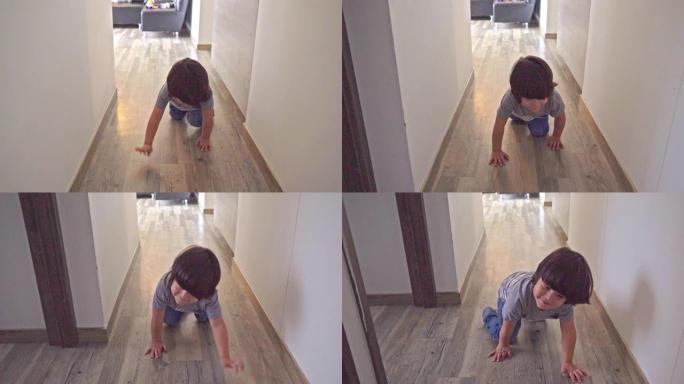 3岁男孩在他的房子周围快速爬行