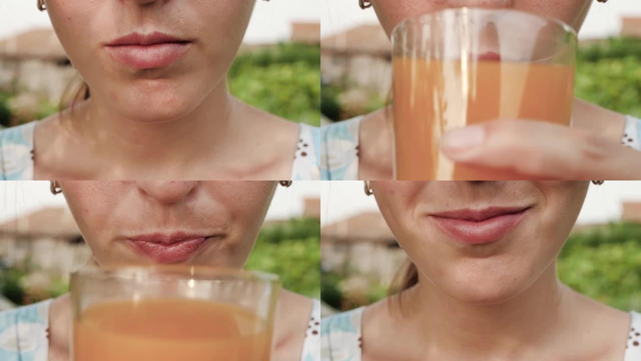 女人正在喝桃汁。女性的手将装有桃汁的玻璃杯带到嘴里，并在大自然的晴天喝。特写
