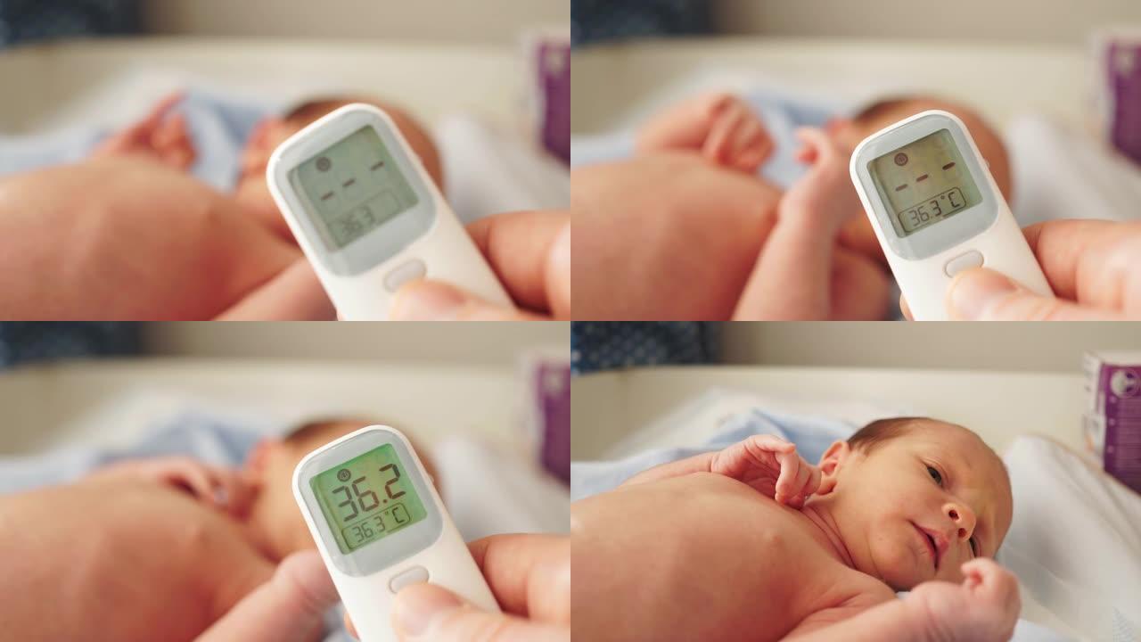 母亲或父亲用数字非接触式温度计测量婴儿温度。这个孩子几个月大。婴儿体温正常。