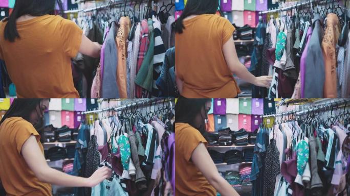 顾客女人在购物商店里挑选衣服