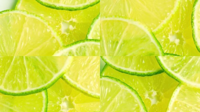石灰片特写，柠檬水果俯视图。旋转