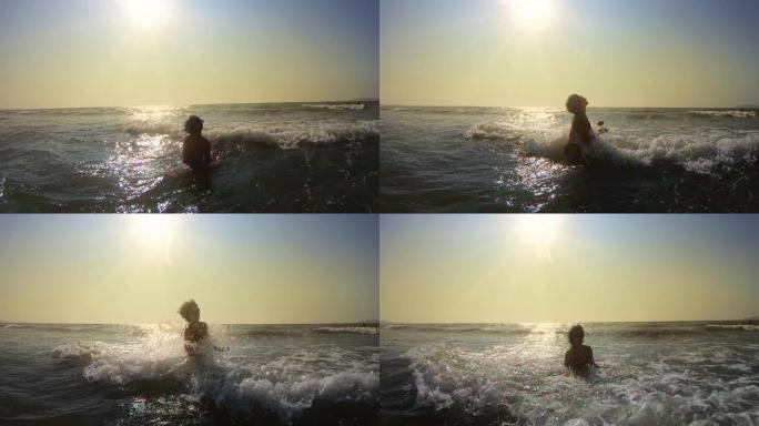 年轻女子在日落时在汹涌的大海中享受高浪，慢动作