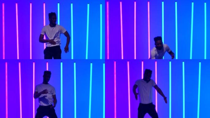 灵活的非裔美国人在多色霓虹灯的背景下在工作室里跳舞。拉丁舞。萨尔萨。巴哈塔。慢动作。特写