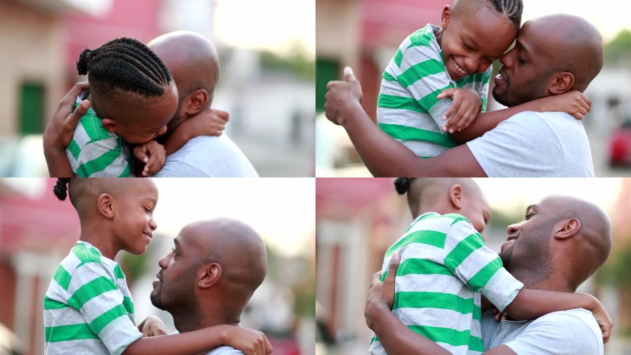 父子俩热爱关怀和感情。非洲爸爸抱着孩子的儿子