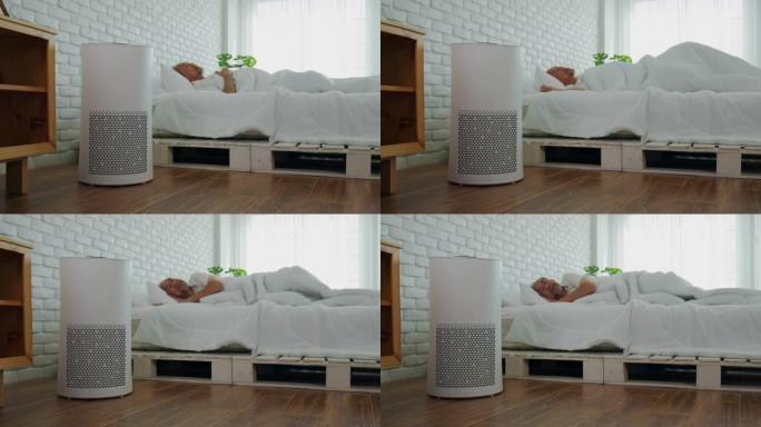 老年人在舒适的白色卧室中使用空气净化器睡觉，用于过滤和清洁灰尘去除家庭中的PM2.5 HEPA，用于