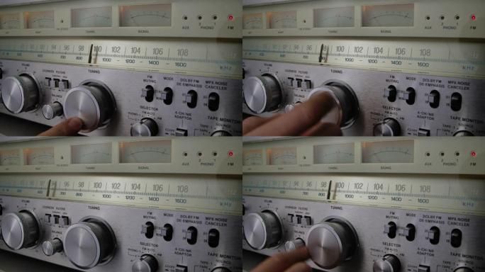 老式收音机接收器和带调频刻度的放大器。男性手按复古接收器的比例调谐模拟射频。在旧收音机上搜索电台。特