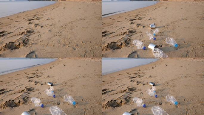 沙滩上的塑料水瓶和铁罐垃圾