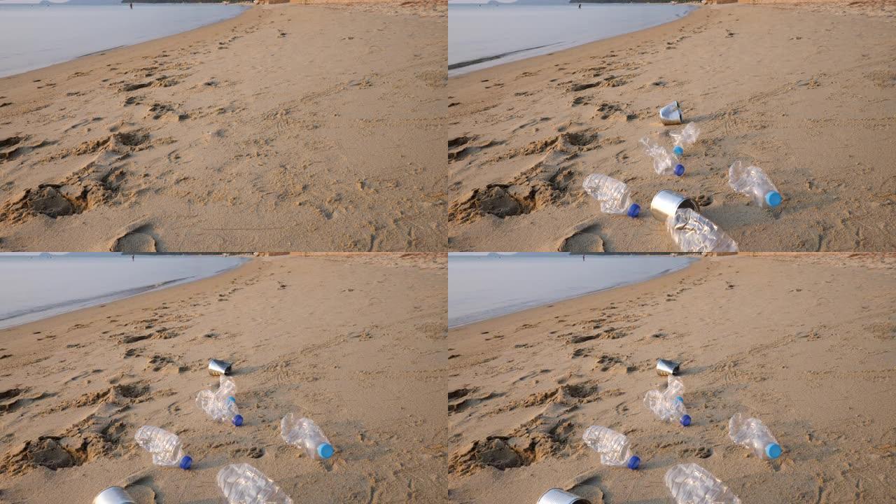沙滩上的塑料水瓶和铁罐垃圾