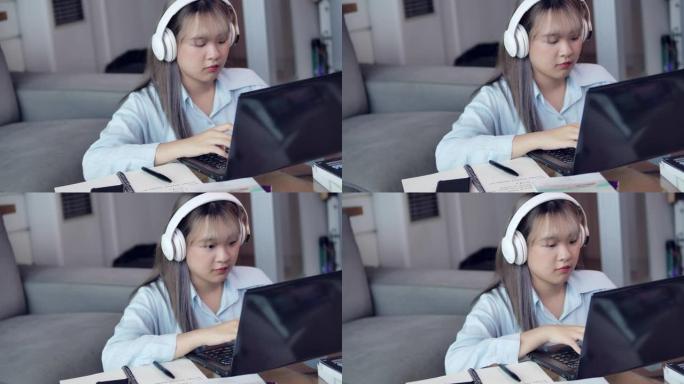在COVID检疫期间，一名亚洲长发少女正在客厅学习家庭在线学习。