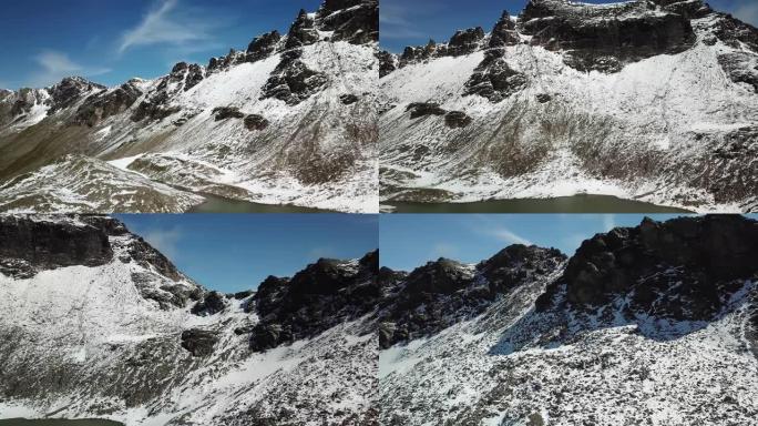 一架无人机拍摄了奥地利Feldseekopf附近的一个湖泊。湖面被积雪包围，部分覆盖了阿尔卑斯山的石