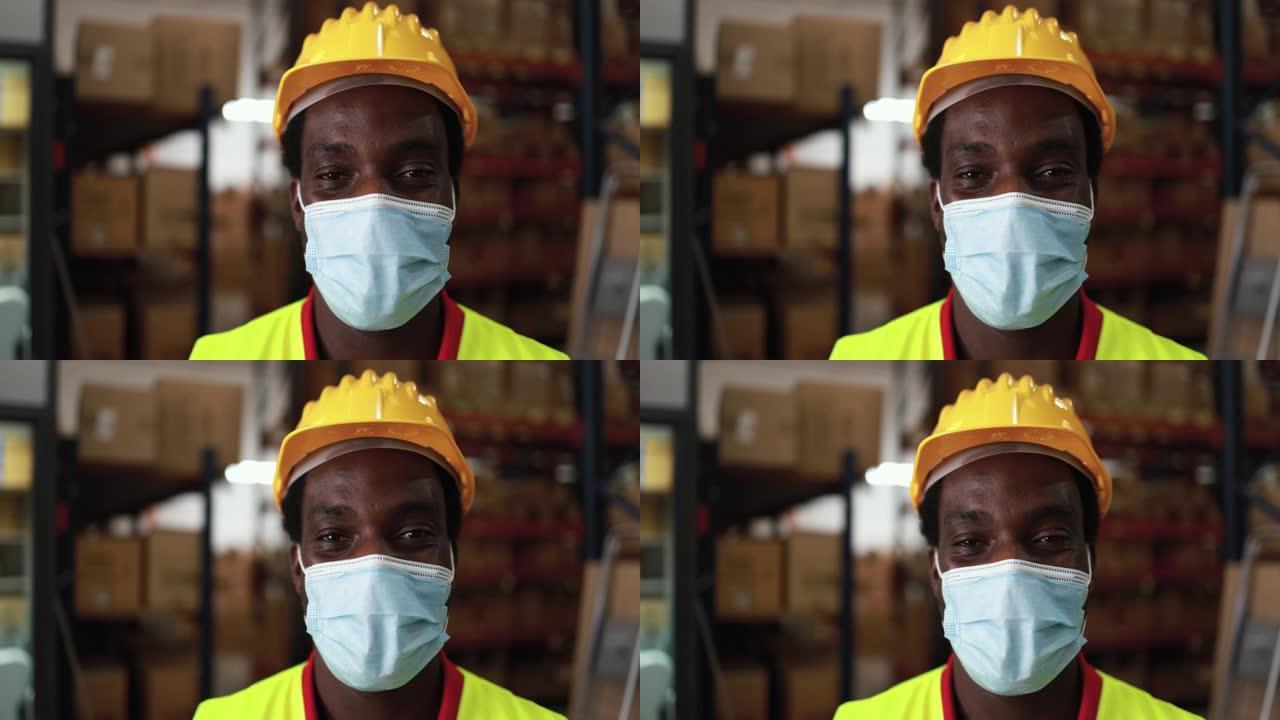 非洲工人男子在送货箱仓库内，戴着冠状病毒爆发的防护口罩