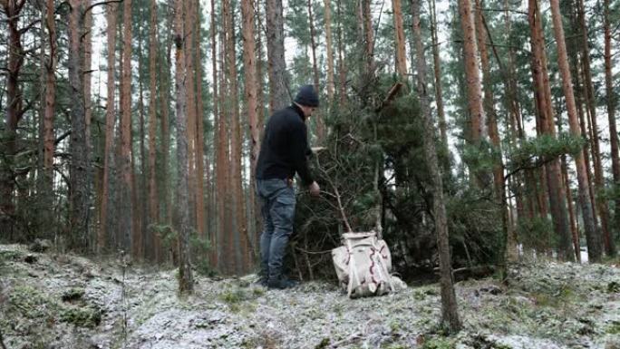 冬季的户外冒险-人在野外建造树枝营地