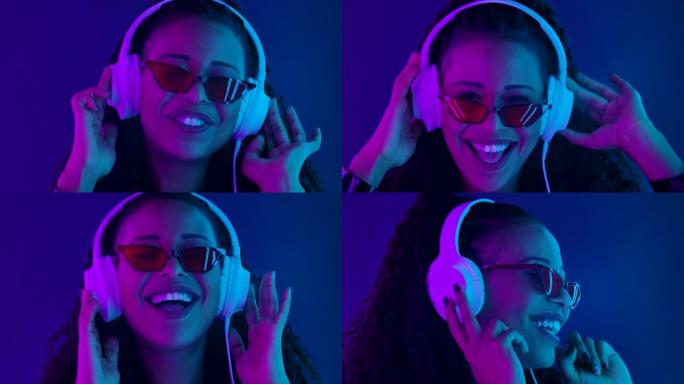 一位年轻可爱的非裔美国人的肖像喜欢用白色大耳机听音乐。用紫色和蓝色霓虹灯照亮的特写脸。慢动作
