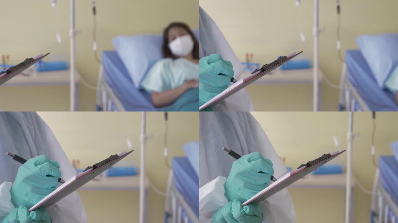 手持并关闭医生的手在医疗手套和PPE服正在写一条关于女病人休息在恢复室的床上的信息。