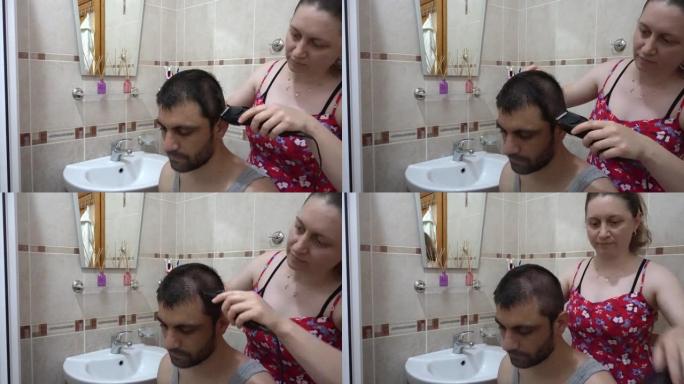 女人用电动剃须刀刮男人的头发