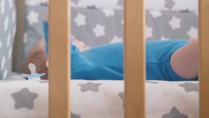 小孩子躺在婴儿床上的裸露腿困扰