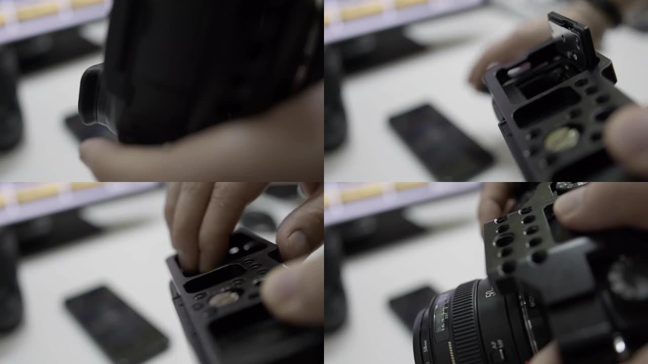 一个男人在DSLR相机中安装电池的特写镜头。