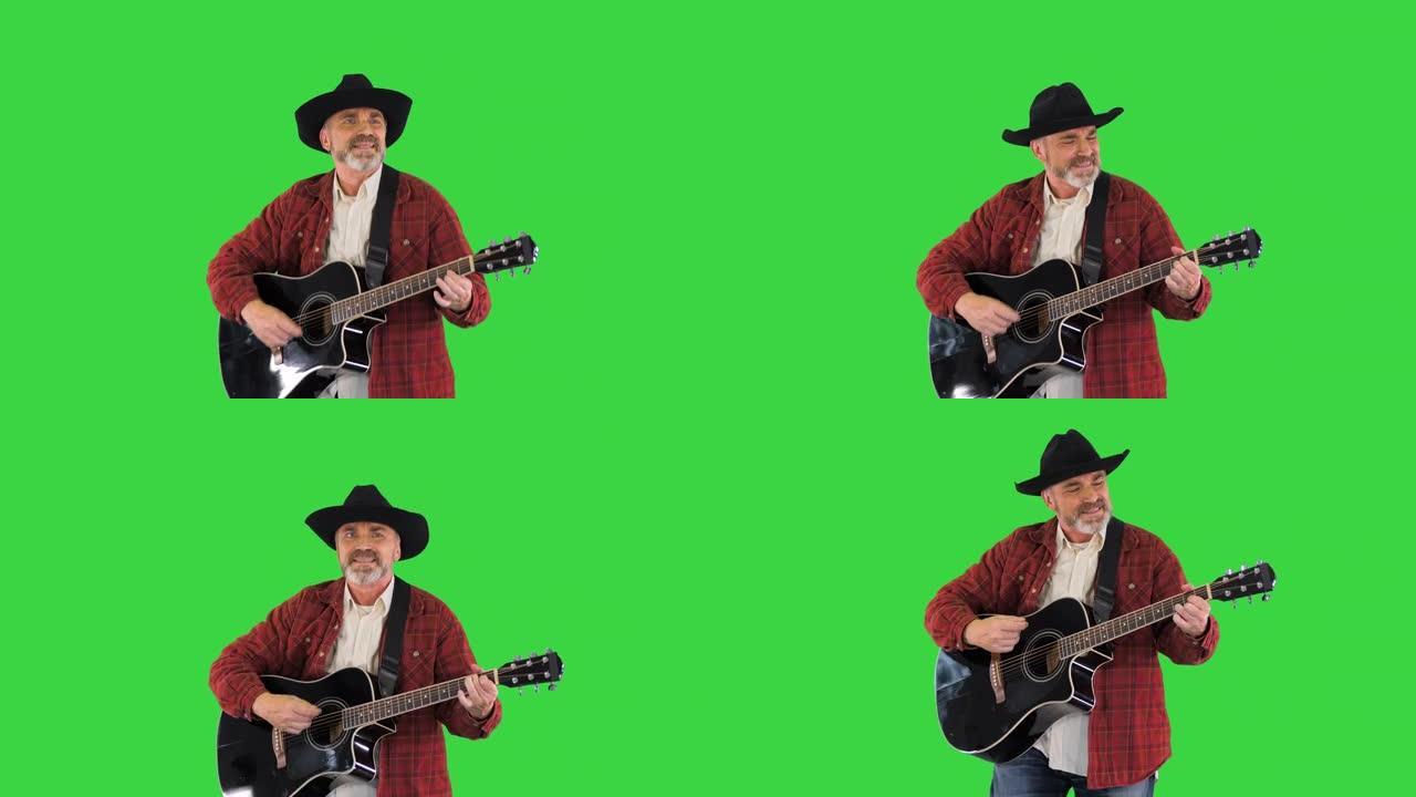 穿着图案衬衫的高级男子在绿色屏幕上唱歌和弹吉他，色键