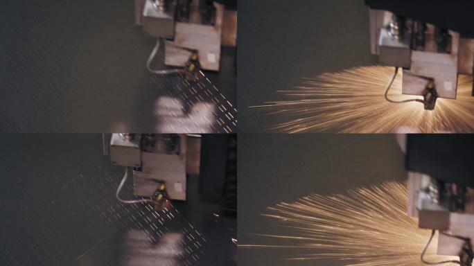 钣金激光切割机。特写。顶视图。现代数控光纤激光器机器正在金属板上切割图案。切割过程中，明亮的燃烧火花