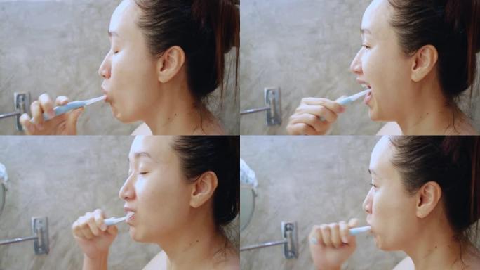 关闭亚洲年轻女子刷牙
