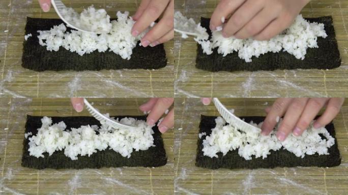 女人把米饭放在紫菜叶上。在家做寿司。特写镜头